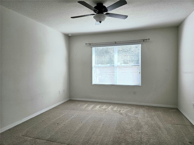 spare room with ceiling fan, carpet floors, and a textured ceiling