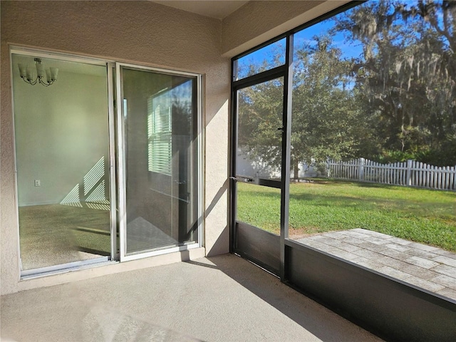 unfurnished sunroom with an inviting chandelier