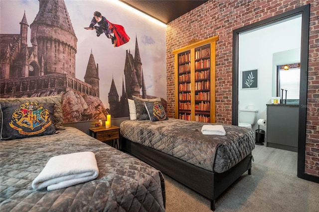 bedroom featuring hardwood / wood-style flooring and brick wall