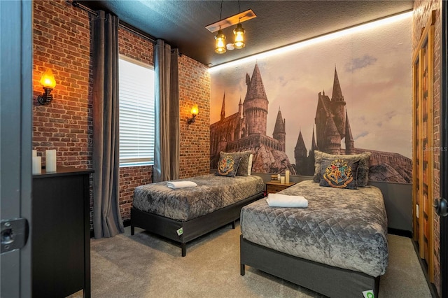 bedroom with carpet floors, a textured ceiling, and brick wall