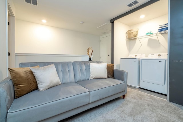 carpeted living room featuring separate washer and dryer