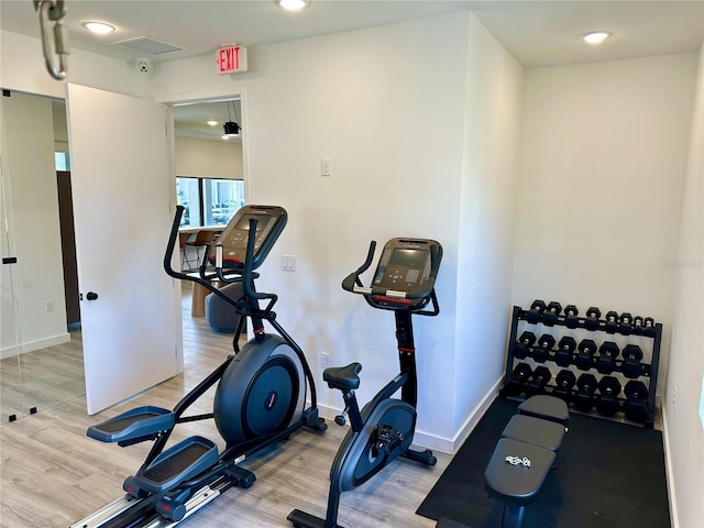 workout area with light hardwood / wood-style floors