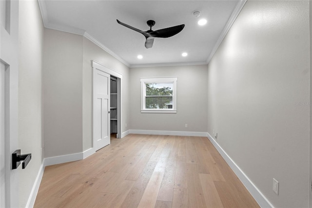 unfurnished bedroom featuring crown molding, a closet, ceiling fan, and light hardwood / wood-style floors