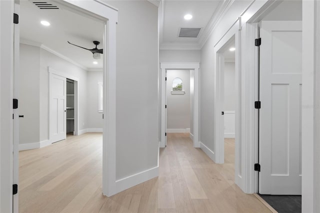 hall with ornamental molding and light wood-type flooring