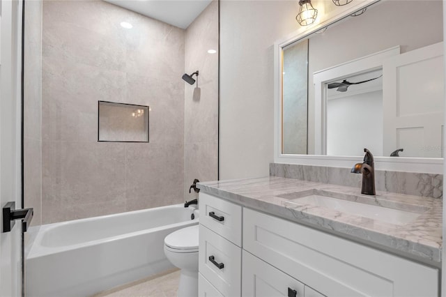 full bathroom with vanity, ceiling fan, tiled shower / bath combo, and toilet