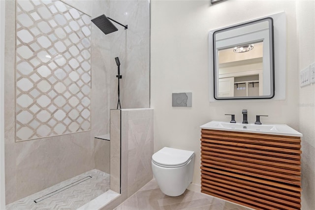 bathroom featuring vanity, a tile shower, and toilet