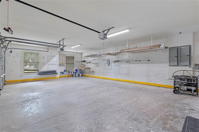 garage featuring a garage door opener and electric panel