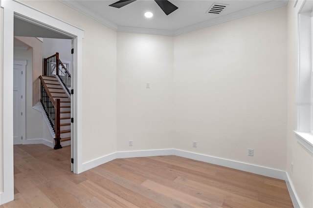 spare room featuring ceiling fan, ornamental molding, and light hardwood / wood-style floors