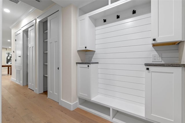 mudroom with crown molding and light wood-type flooring