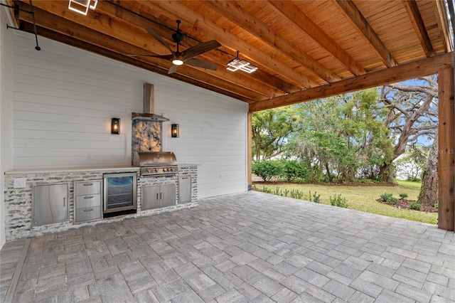 view of patio / terrace featuring wine cooler, area for grilling, grilling area, and ceiling fan