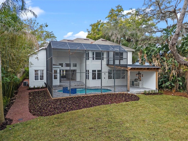 back of house featuring a lanai, a patio area, and a lawn