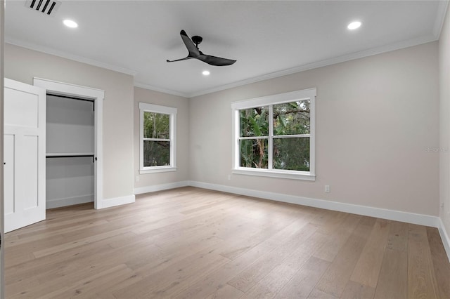 unfurnished bedroom with light wood finished floors, visible vents, baseboards, and ornamental molding