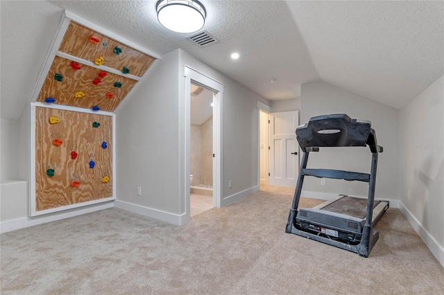 exercise room with baseboards, visible vents, carpet floors, lofted ceiling, and a textured ceiling