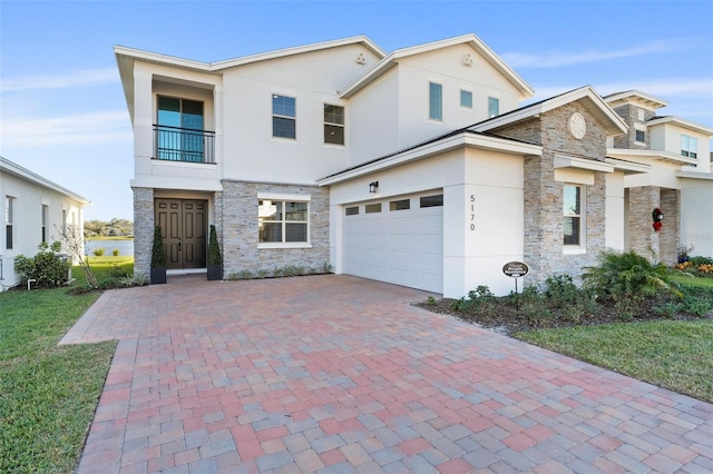 view of front of house featuring a garage and a balcony