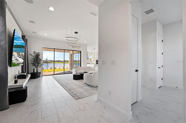 interior space featuring a textured ceiling and a notable chandelier