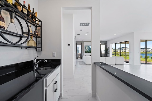 kitchen featuring white cabinets and sink