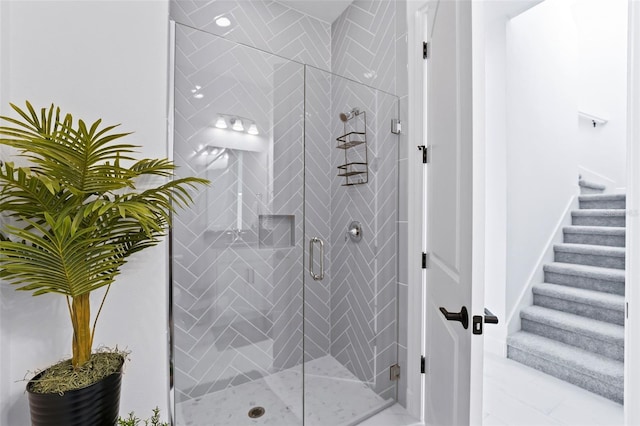 bathroom featuring a shower with door