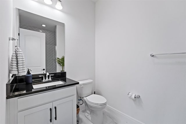 bathroom featuring vanity and toilet