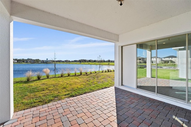 view of patio with a water view