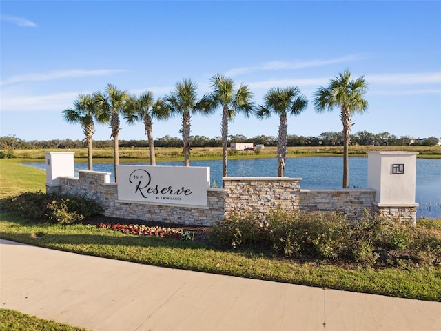 community / neighborhood sign featuring a water view