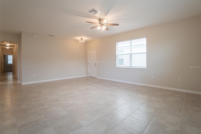 tiled empty room with ceiling fan