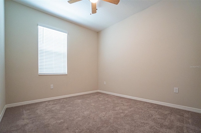 carpeted spare room with ceiling fan and lofted ceiling