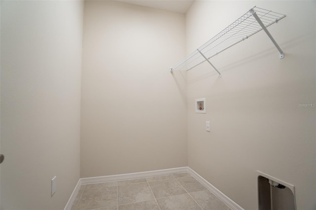 laundry room featuring hookup for a washing machine and light tile patterned flooring