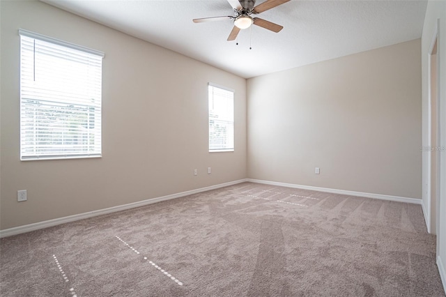 carpeted empty room featuring ceiling fan