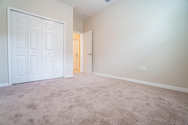 unfurnished bedroom featuring a closet and carpet