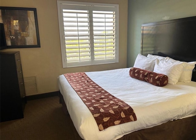 bedroom featuring dark carpet