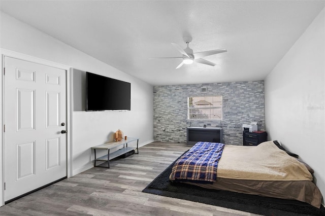 bedroom with ceiling fan and light wood-type flooring