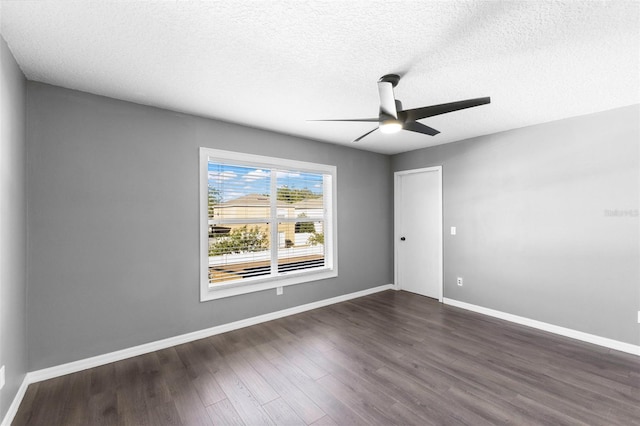 spare room with dark hardwood / wood-style floors, ceiling fan, and a textured ceiling