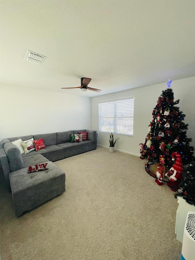 living room with ceiling fan and carpet