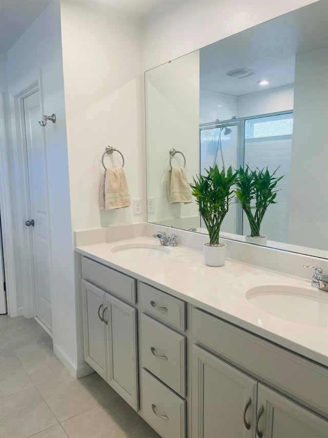 bathroom featuring tile patterned floors, vanity, and an enclosed shower