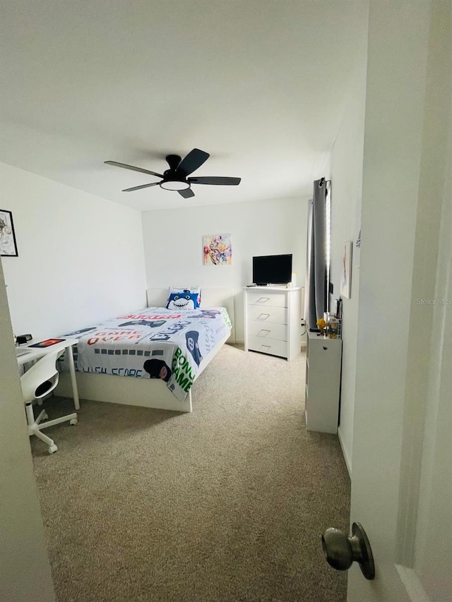 bedroom with ceiling fan and light carpet