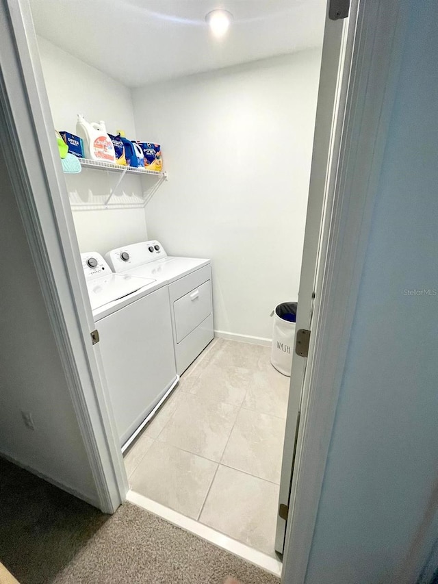 washroom with independent washer and dryer and light tile patterned floors