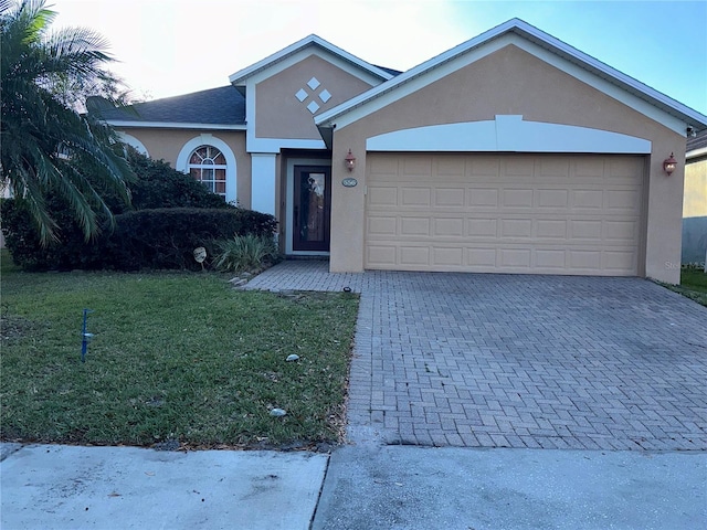 view of front of home with a front lawn and a garage