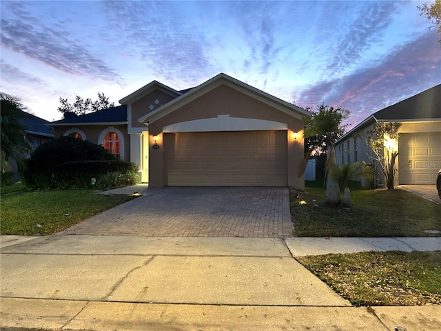 view of front of property with a lawn and a garage