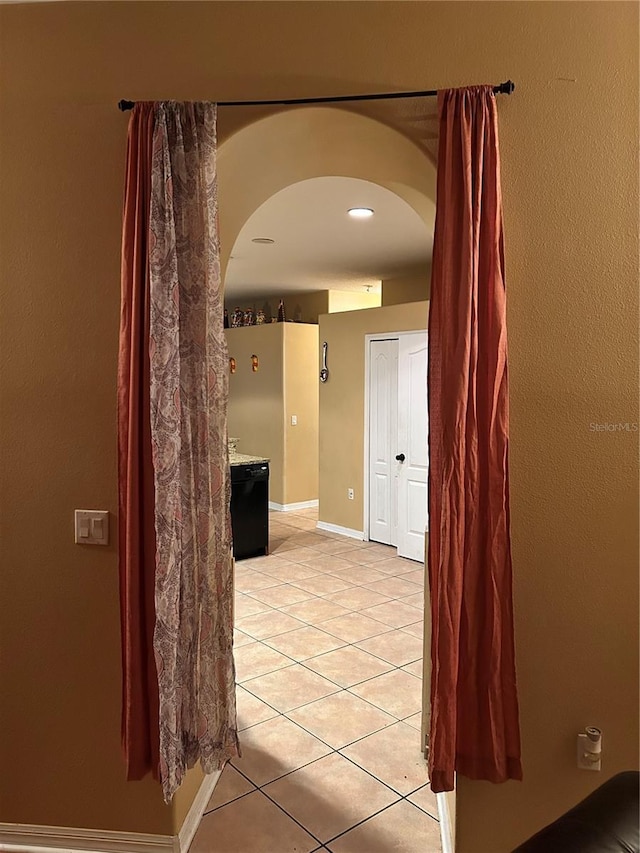 hallway featuring light tile patterned floors