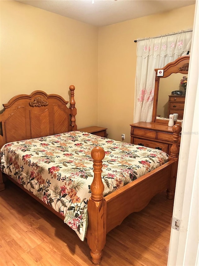 bedroom with hardwood / wood-style floors