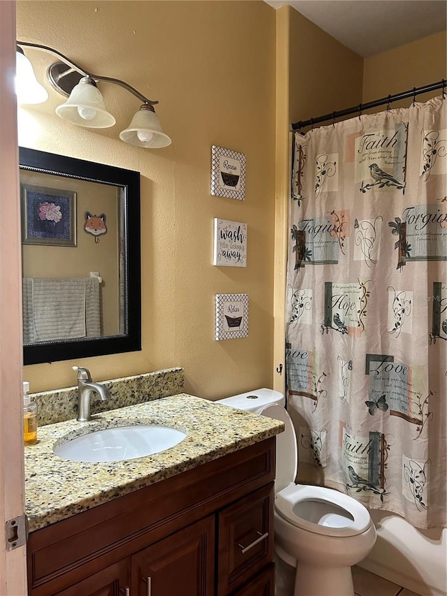 bathroom with vanity, toilet, and walk in shower