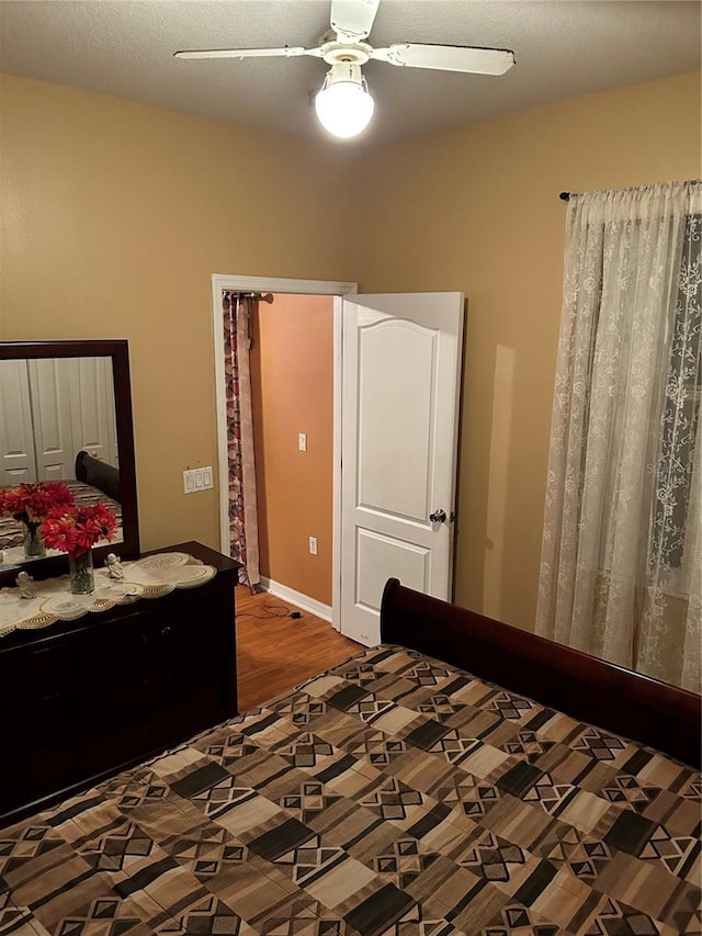 bedroom featuring ceiling fan and hardwood / wood-style floors