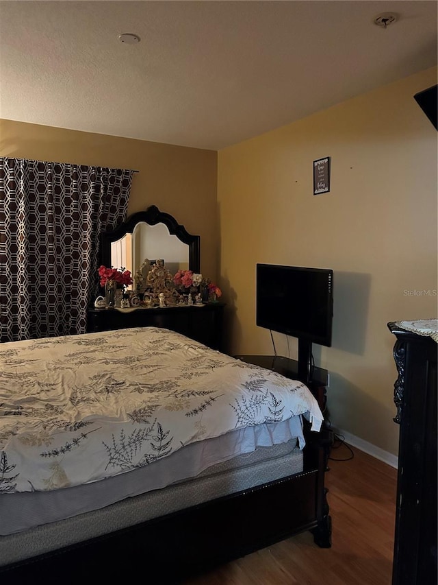 bedroom with hardwood / wood-style floors