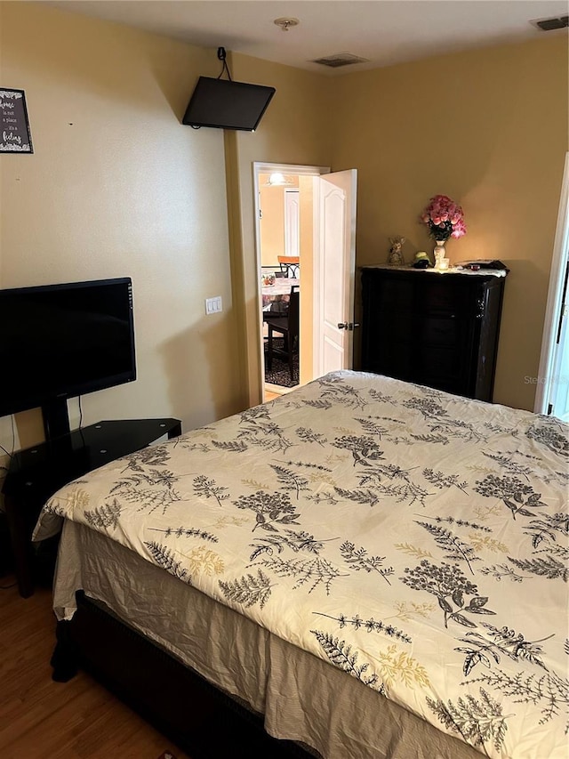 bedroom with hardwood / wood-style floors