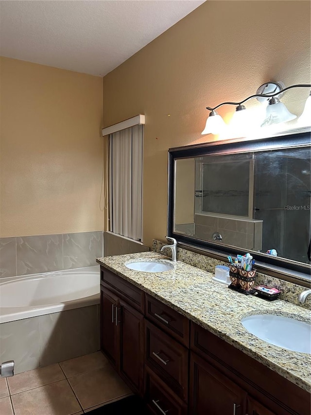 bathroom with vanity, a tub to relax in, and tile patterned floors