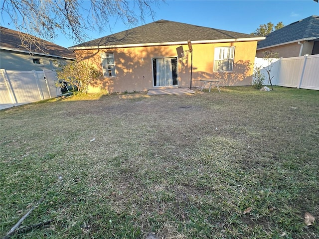 rear view of house with a yard