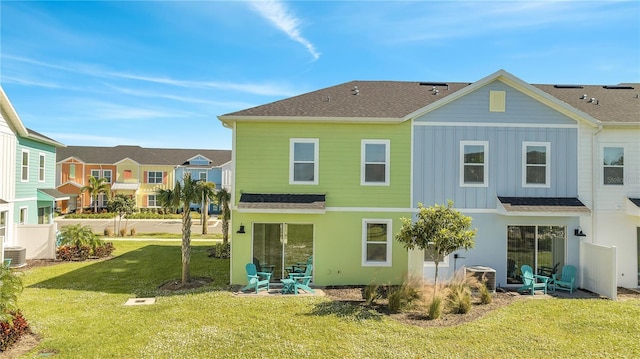 rear view of property featuring a yard