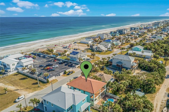 birds eye view of property with a view of the beach and a water view