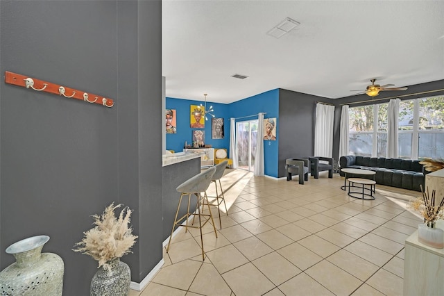 interior space with ceiling fan with notable chandelier