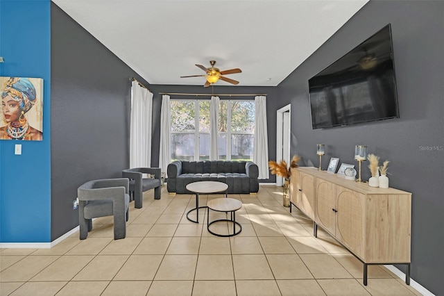 living room featuring light tile patterned floors and ceiling fan